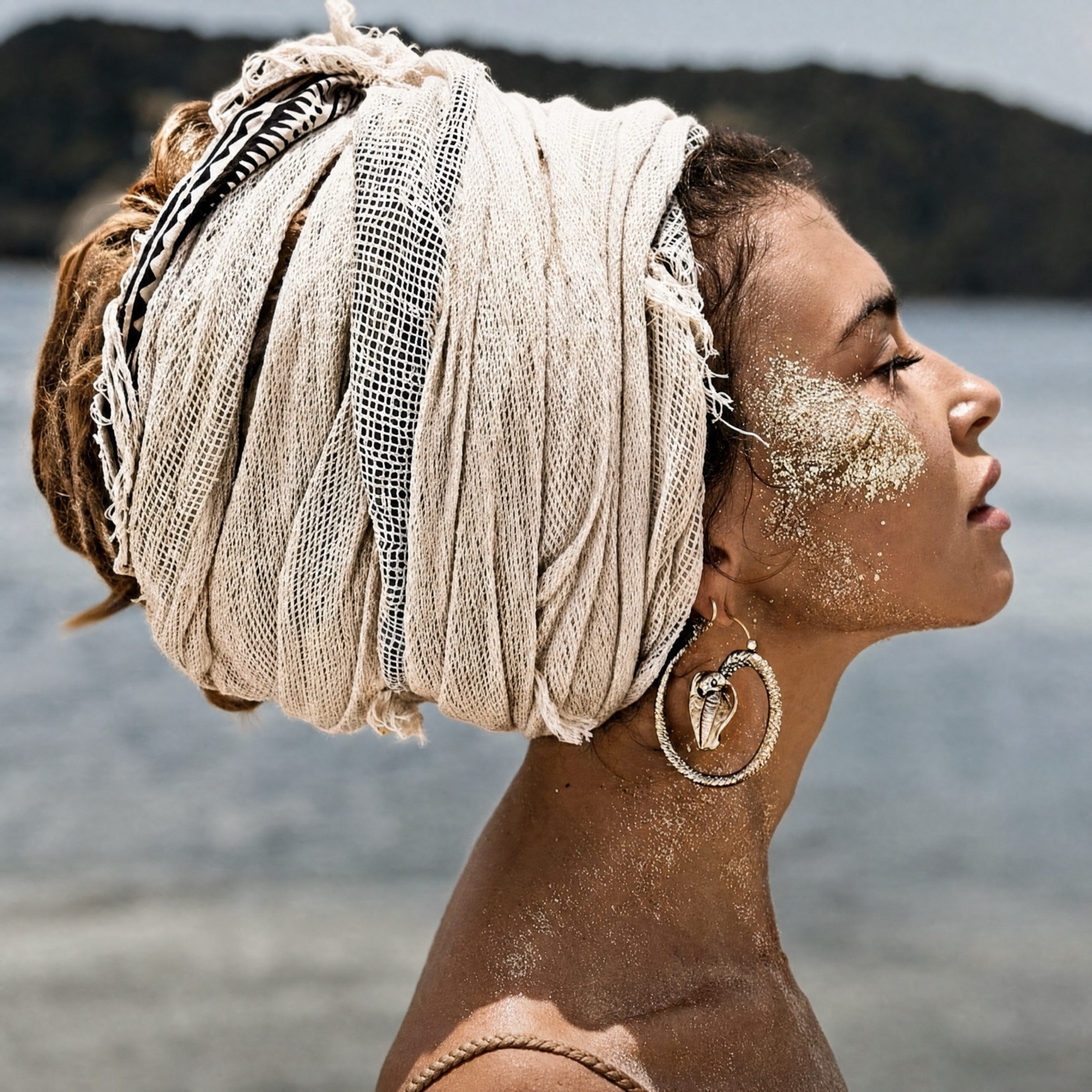 Woman in a linen head wrap by the sea